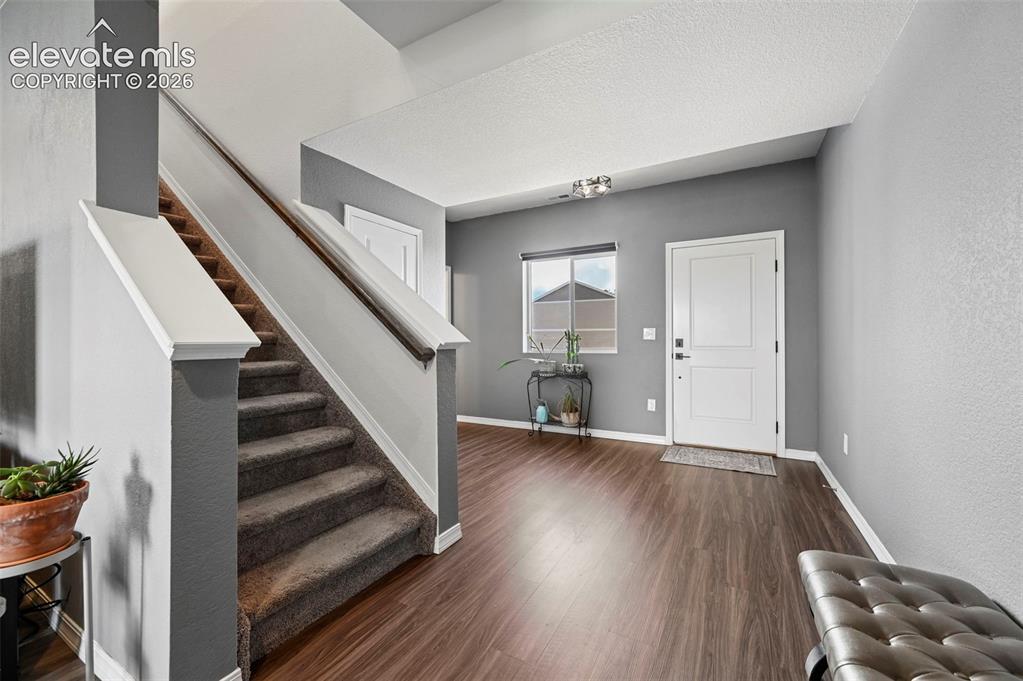 Image 3 of 28: huge entry way with coat closet, large window, and LVP flooring