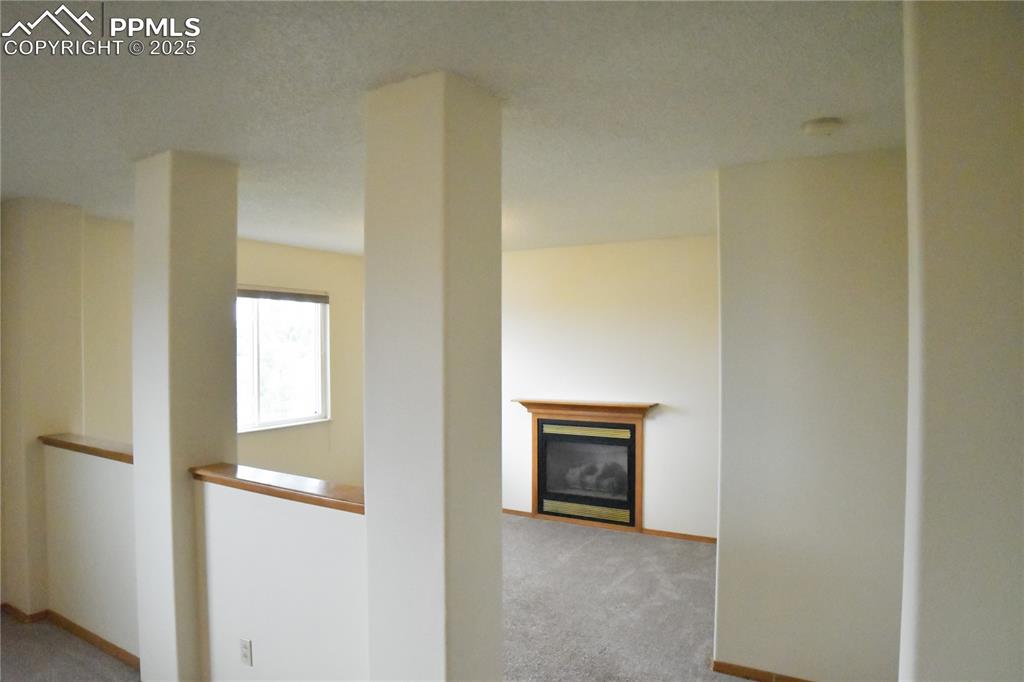 Image 17 of 48: Corridor with light colored carpet and baseboards