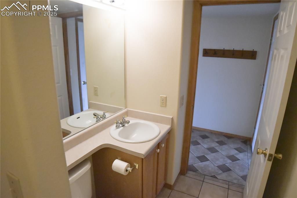 Image 21 of 48: Half bathroom featuring vanity and tile patterned flooring