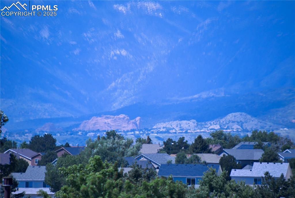 Image 33 of 48: Garden of The Gods, from primary bedroom background featuring nearby suburb