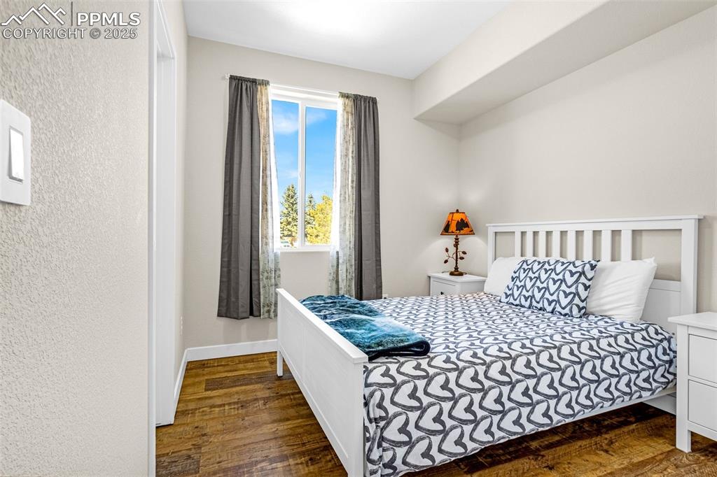Image 10 of 37: Main Level Bedroom with engineered hardwood floor, closet and main level ba