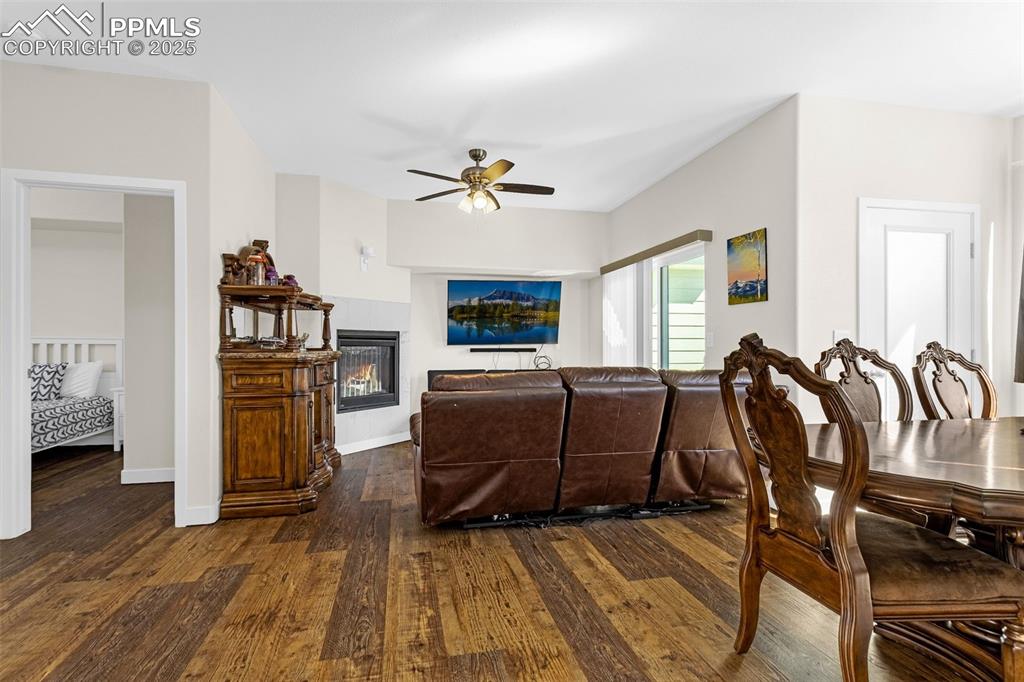 Image 4 of 37: Living room featuring a gas fireplace, engineered hardwood floor, walk-out 