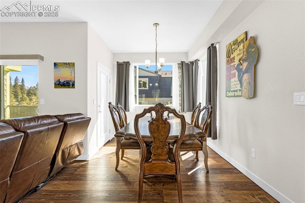 Image 7 of 37: Dining area featuring engineered hardwood floor and walk-out to private bal