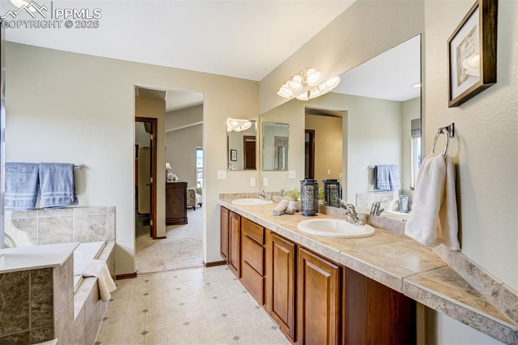 Image 28 of 45: Vaulted ceilings and an open upper-level landing combine to create a light-