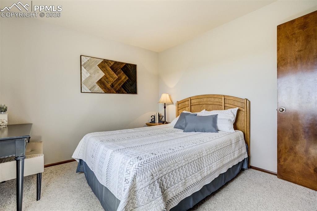 Image 29 of 45: The primary bedroom is spacious with a sliding barn door to separate the be