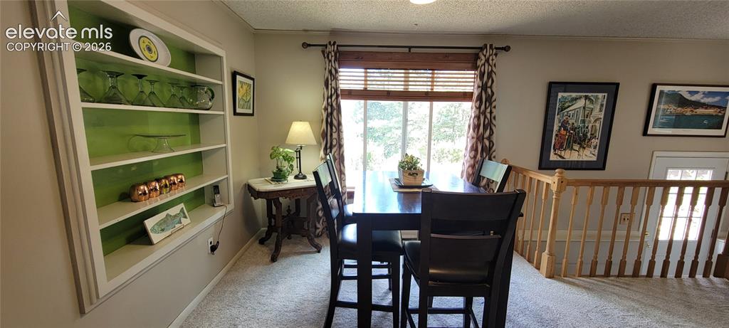 Image 13 of 30: Built-in shelving with accent backing, neutral wall color, and window with 