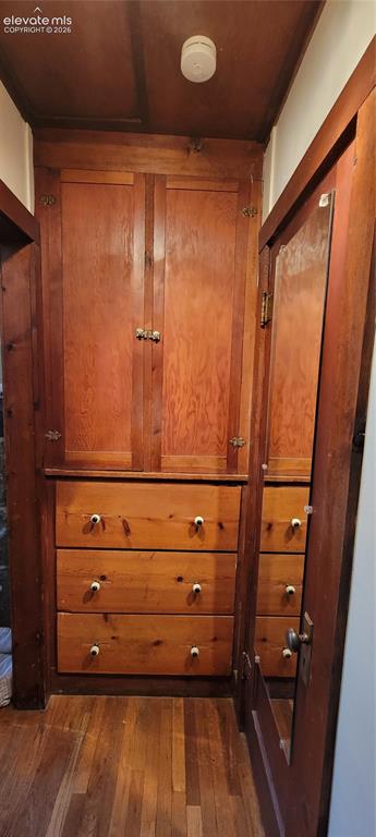 Image 15 of 30: Built-in wood cabinetry featuring upper storage doors and three lower drawe