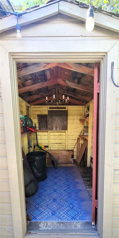 Image 26 of 30: She Shed, located off of back patio. Gable roofline with exposed wood beams