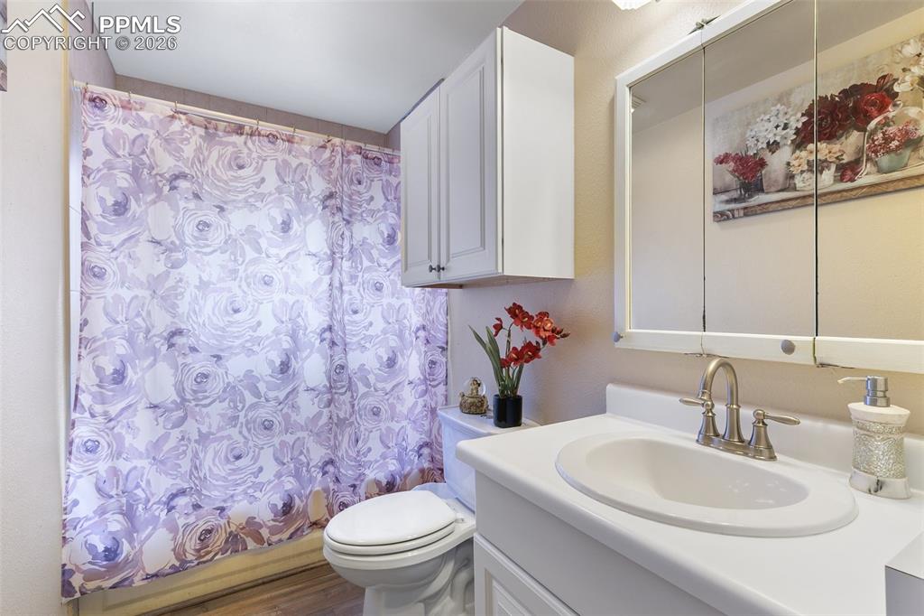 Image 14 of 29: Bathroom with vanity and shower / bathtub combination with curtain