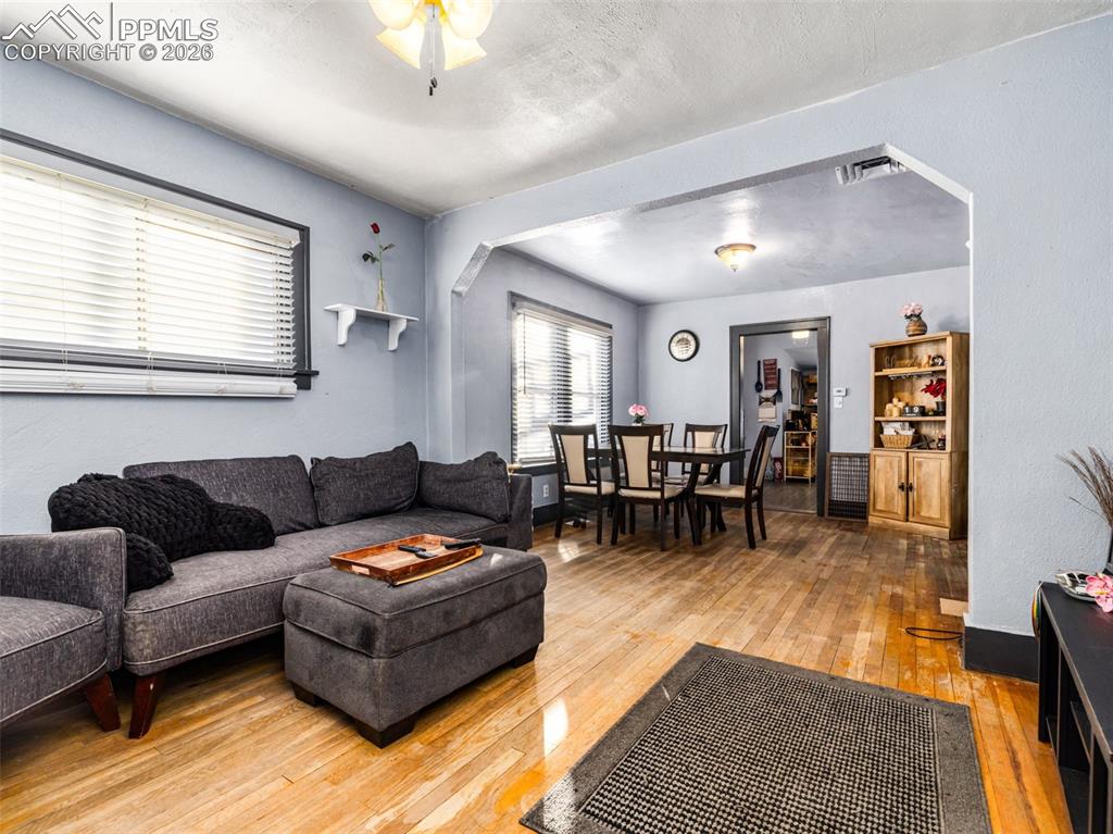 Image 2 of 25: Hardwood floors, natural sunlight in this large living room