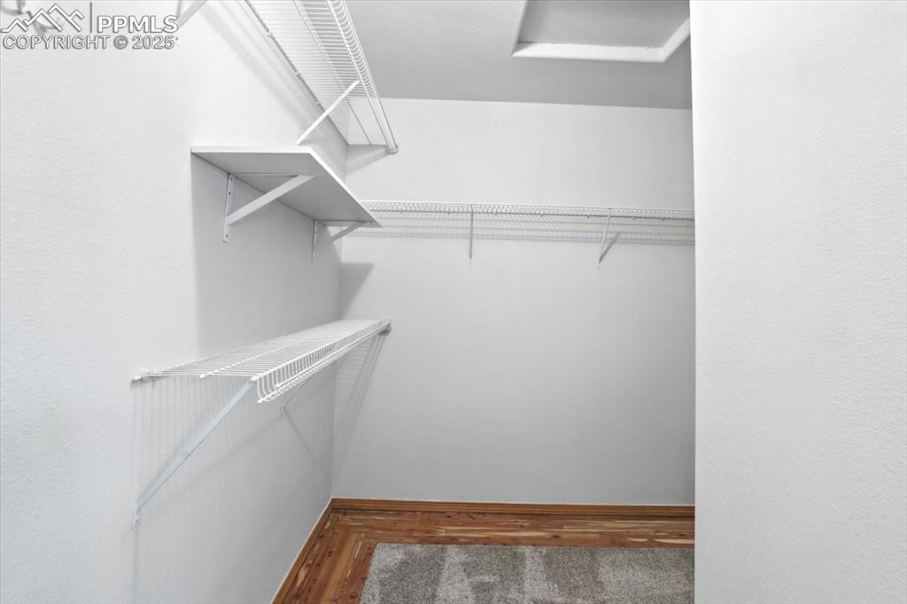 Image 11 of 41: Large L Shaped closet with ventalated shelving and cedar framed flooring