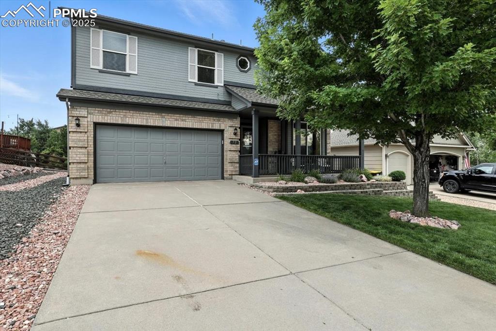Image 2 of 41: Front of home with covered front entry and sitting porch