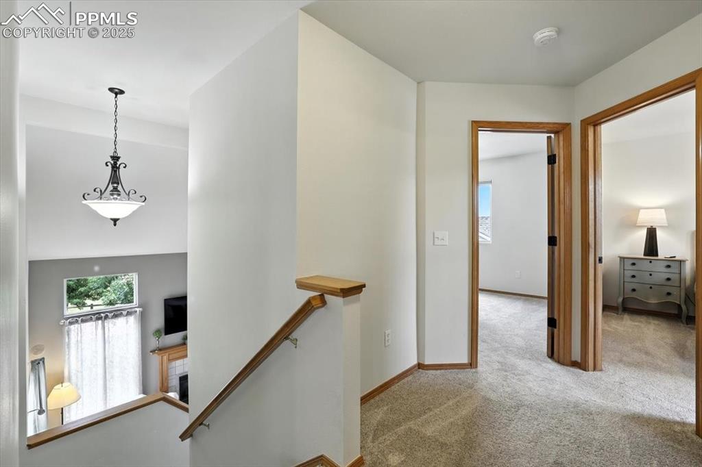 Image 21 of 41: Upper hall way has beautiful overlook to living room and two secondary bedr