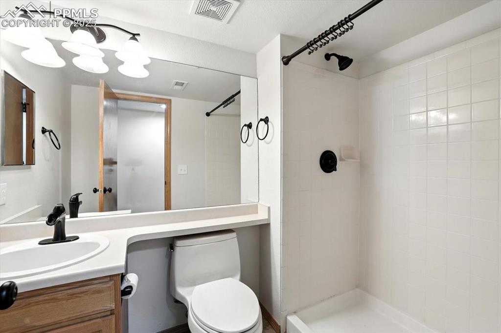 Image 27 of 41: Basement bath features updated fixures and tiled walk in shower