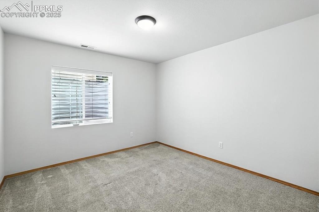 Image 28 of 41: Basement bedroom has nearly garden level windows and is freshly updated