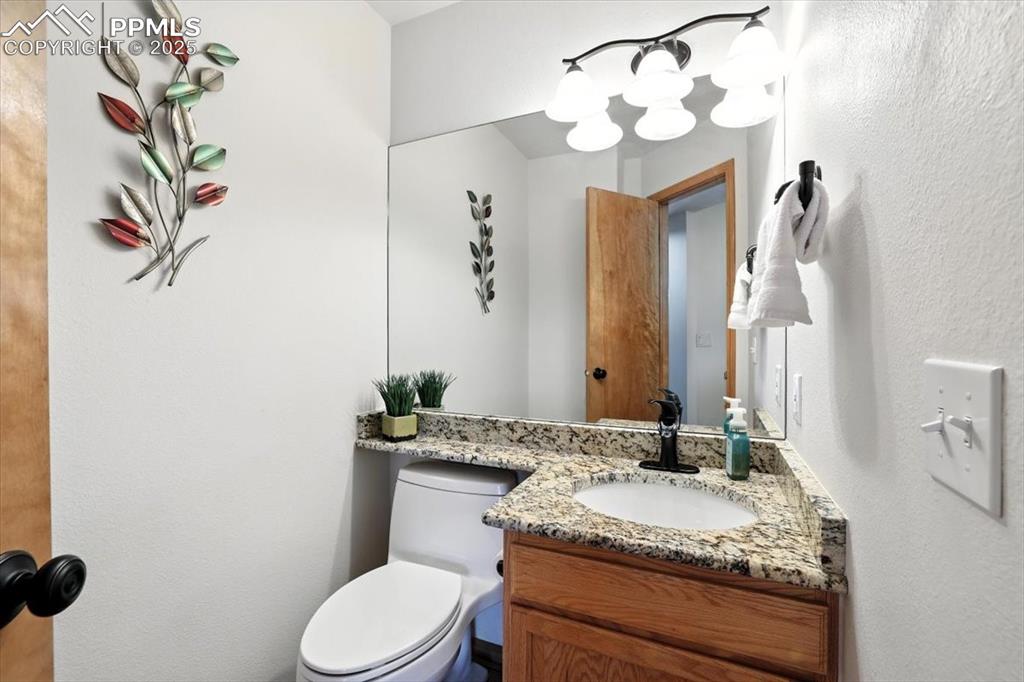 Image 30 of 41: Half bath on main floor has granite countertops and undermount sink