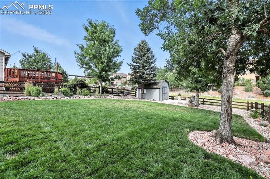 Image 35 of 41: manicured back yard is ready for the best of summer