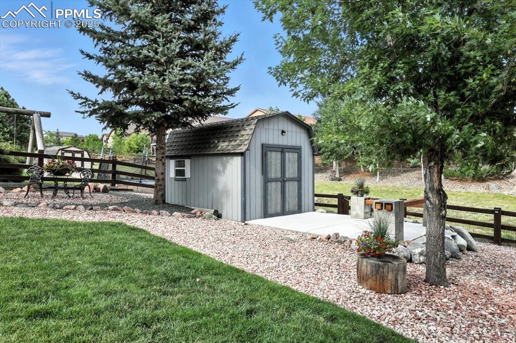 Image 36 of 41: Shed with freshly poured concrete slab and access to green space behind hom