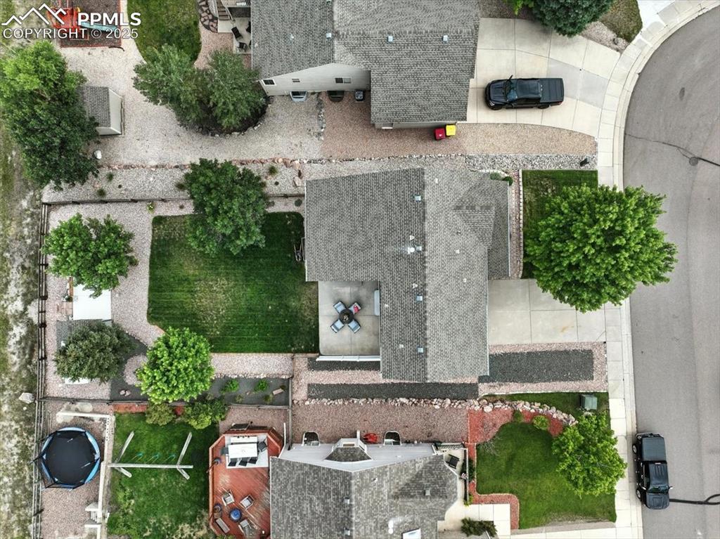 Image 39 of 41: Drone shot from directly above the home shows RV Parking, turf grass and fe