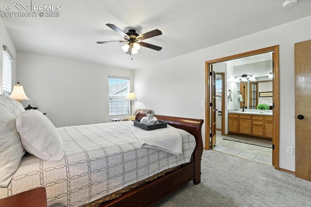Image 8 of 41: Adjacent primary bathroom with french door entrance