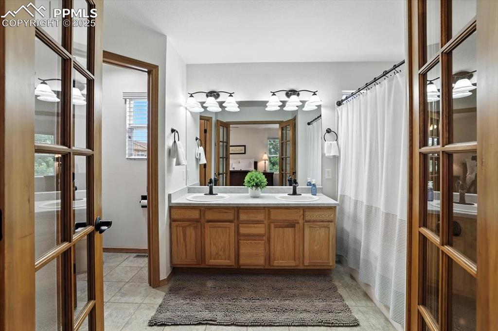 Image 9 of 41: Double vanity, water closet, garden soaking tub shower is generous