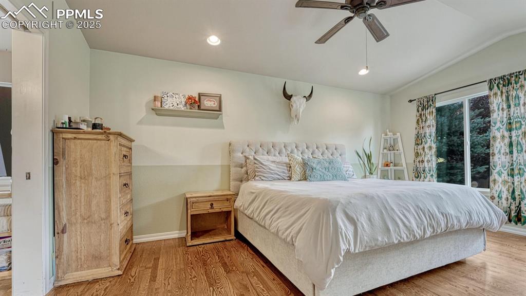 Image 14 of 44: Bedroom featuring recessed lighting, wood finished floors, vaulted ceiling,