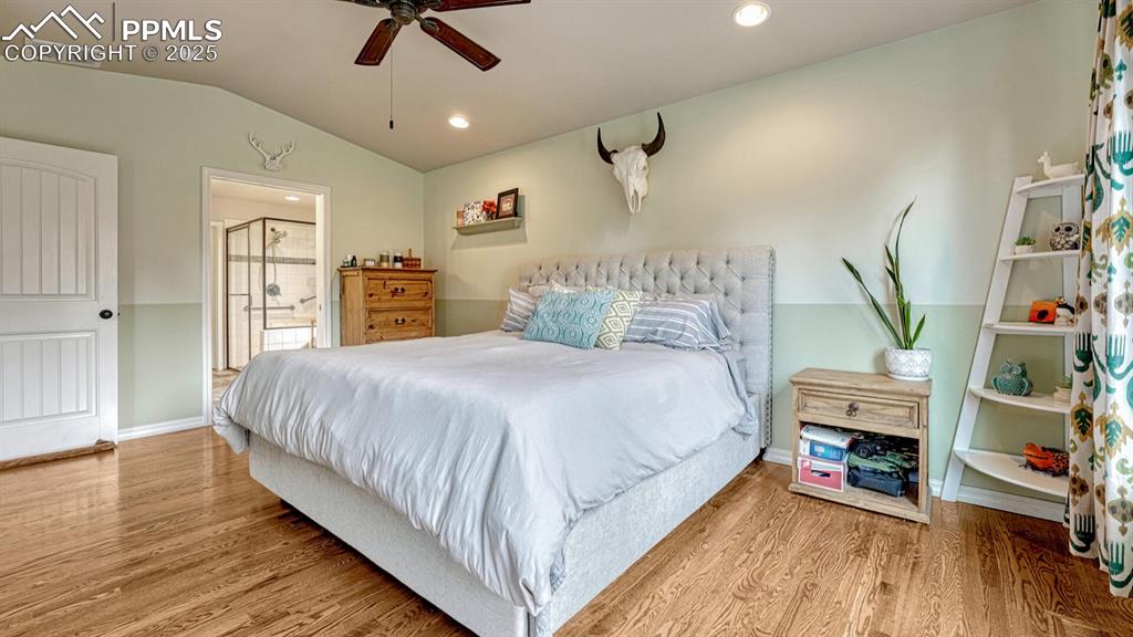 Image 15 of 44: Bedroom featuring lofted ceiling, light wood finished floors, recessed ligh