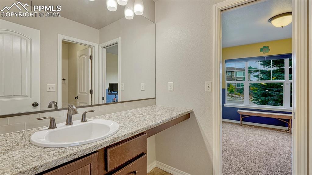 Image 27 of 44: Bathroom featuring vanity and a textured wall