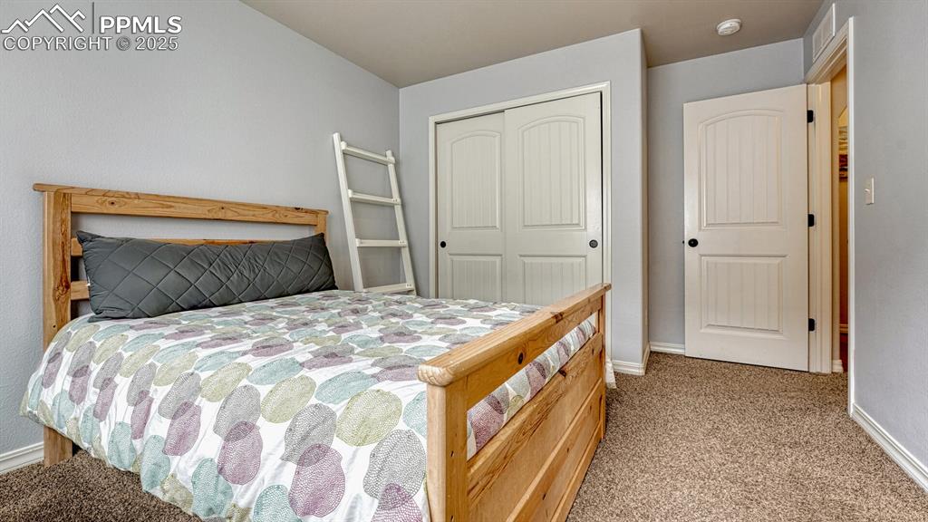 Image 28 of 44: Bedroom with light carpet and a closet