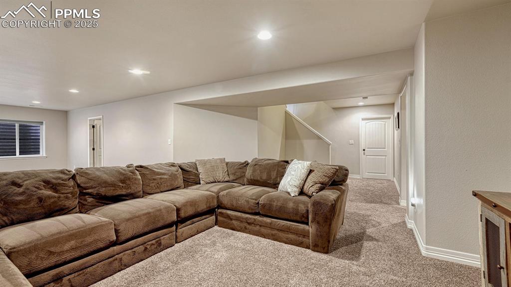 Image 30 of 44: Carpeted living area with baseboards and recessed lighting