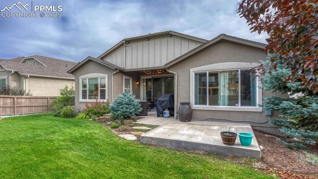 Image 42 of 44: Rear view of house with a patio and stucco siding