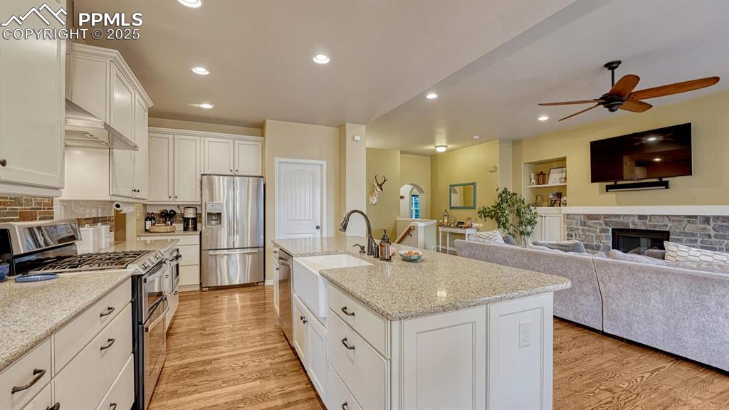 Image 9 of 44: Kitchen featuring appliances with stainless steel finishes, white cabinetry