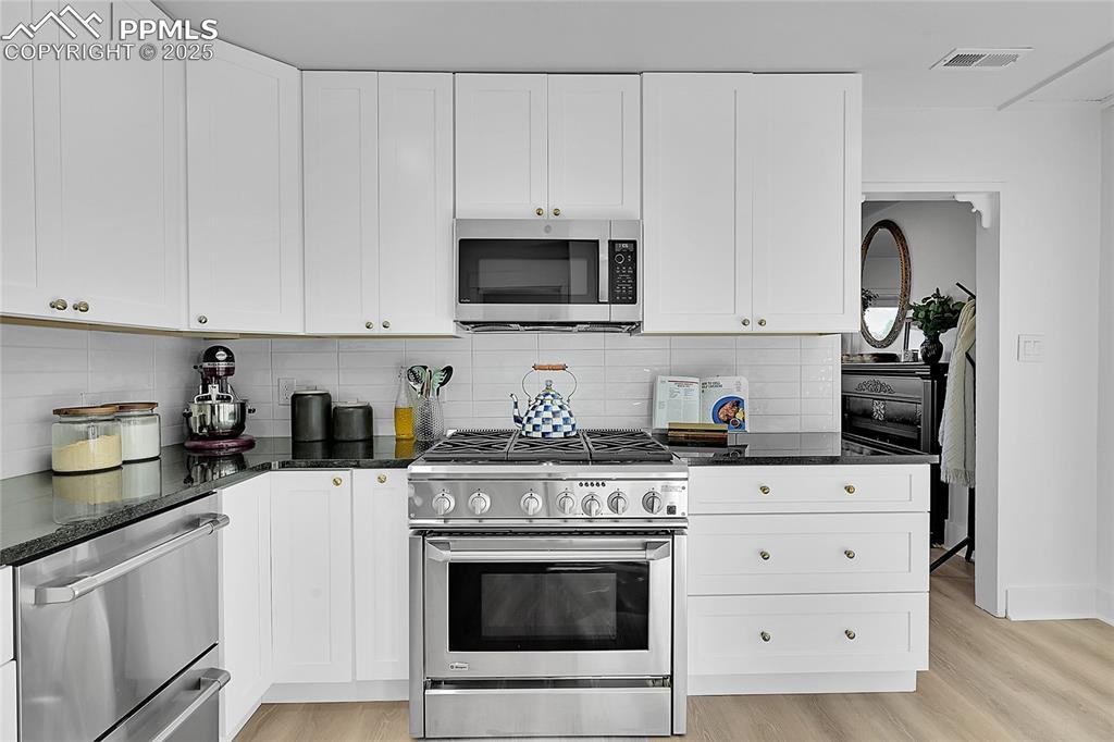 Image 13 of 47: New Everything- tile, stone, cabinetry and ss appliances