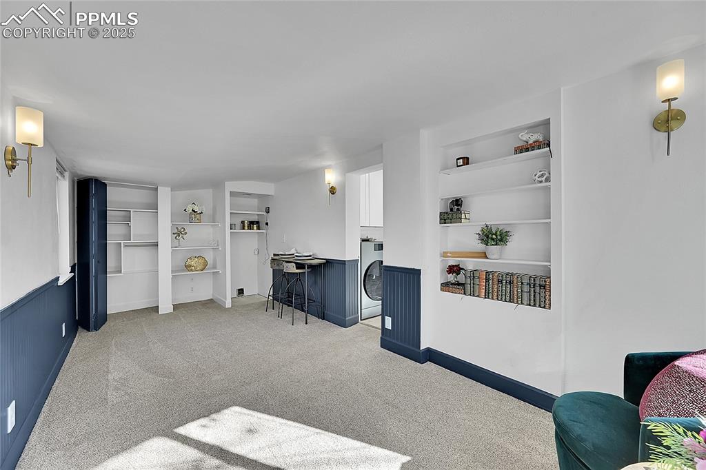 Image 17 of 47: Sunroom w/ built in shelving, loads of storage & tons of space