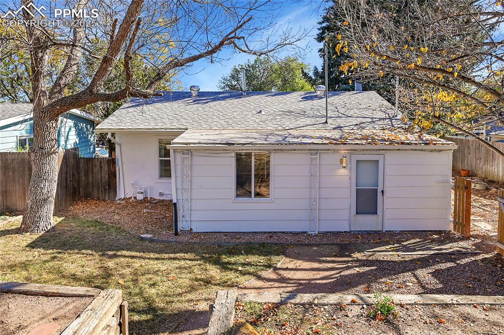 Image 31 of 47: Back of house featuring a Class 4 hail resistant shingled roof