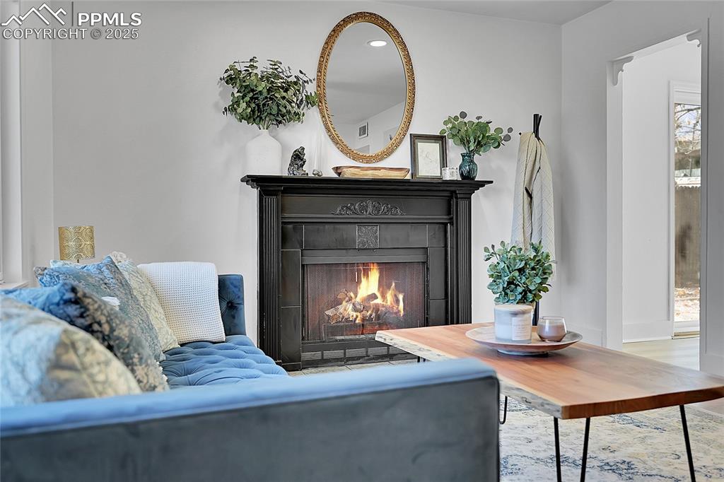 Image 6 of 47: Wood burning fireplace in living room