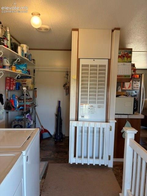 Image 22 of 39: Mudroom/Laundry with gate to close off space for pets or littles.