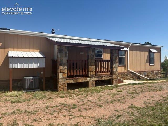 Image 35 of 39: Back of the home, rear patio.
