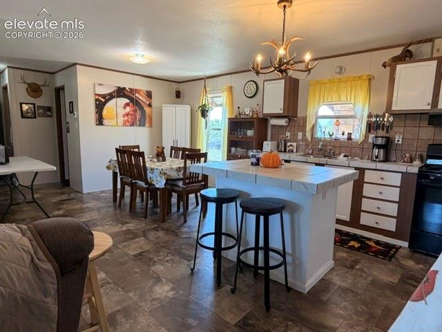 Image 8 of 39: Kitchen island, Pantry Cabinet and newer appliances!