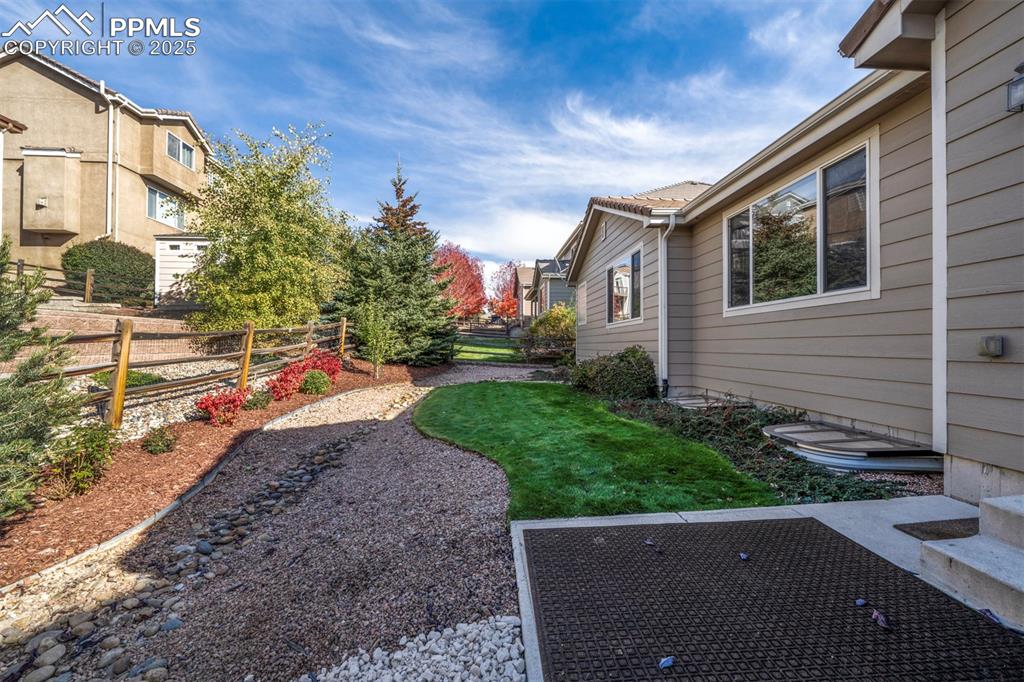 Image 5 of 38: Fenced low maintenance yard and paito