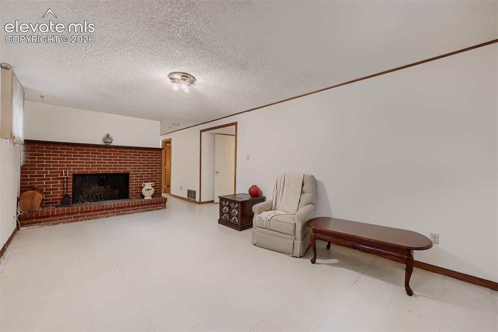 Image 20 of 28: Family Room with wood burning fireplace
