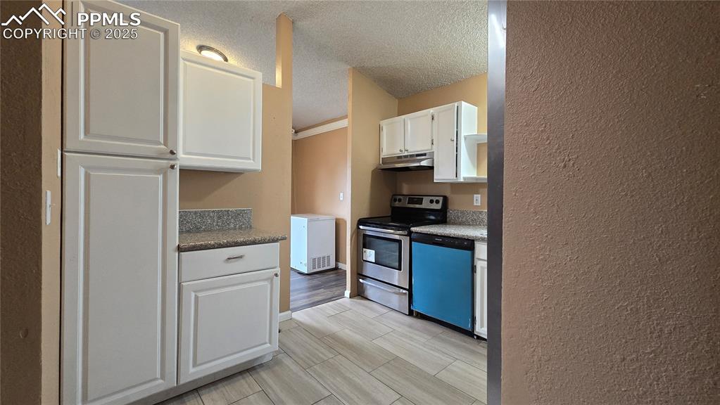 Image 10 of 42: Kitchen featuring white cabinets, electric stove, dishwasher, white refrige