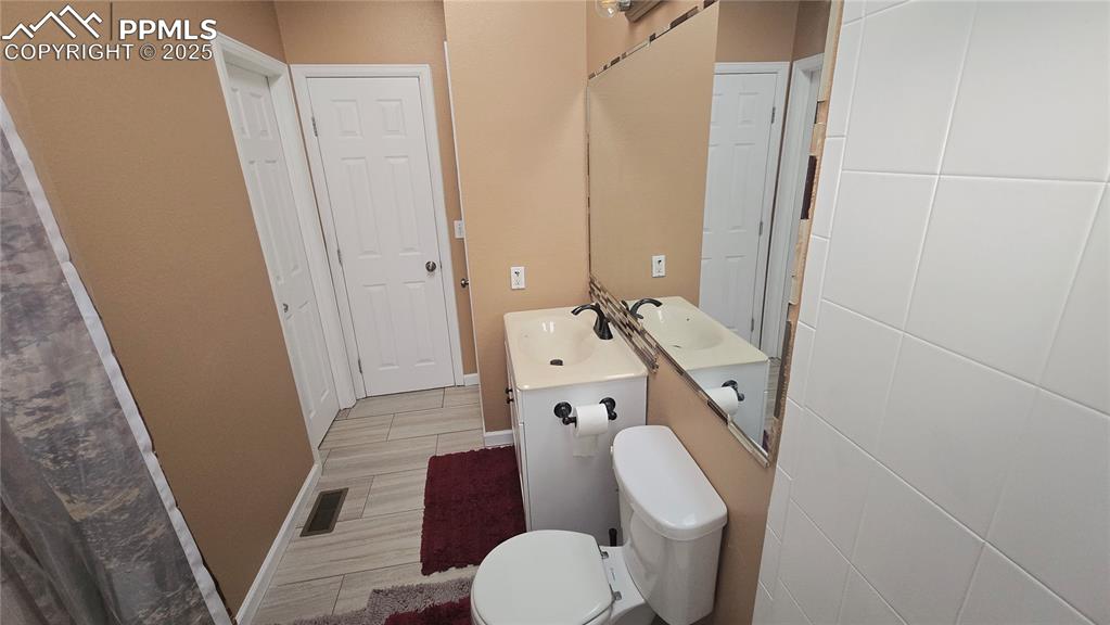 Image 15 of 42: Full bath featuring light wood-style floors and vanity
