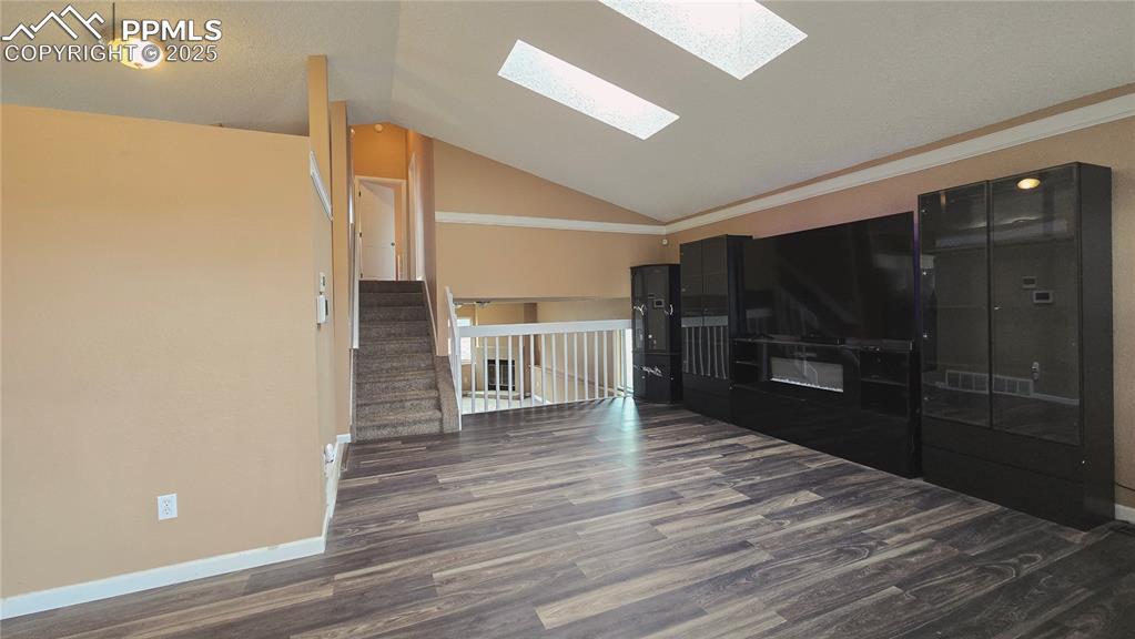 Image 2 of 42: Entryway featuring dark wood-style laminate flooring, high ceiling, plenty 