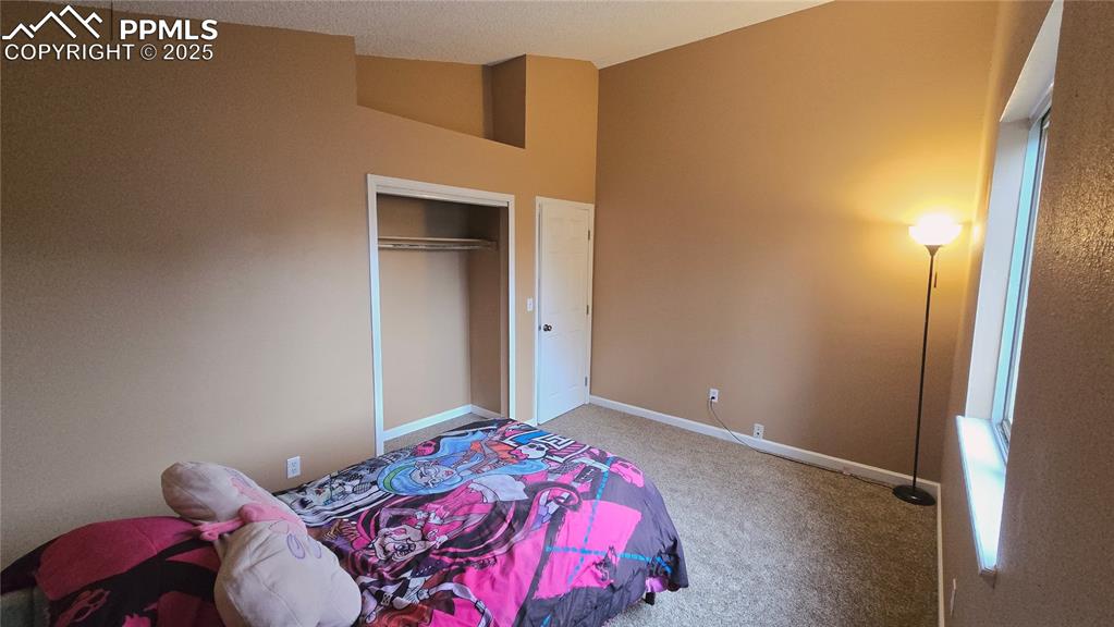 Image 23 of 42: Carpeted bedroom featuring baseboards and a closet