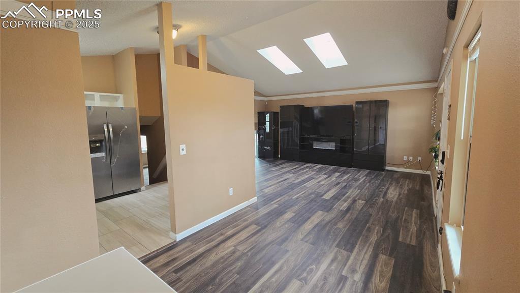 Image 7 of 42: Unfurnished living room featuring dark wood finished floors, ornamental mol