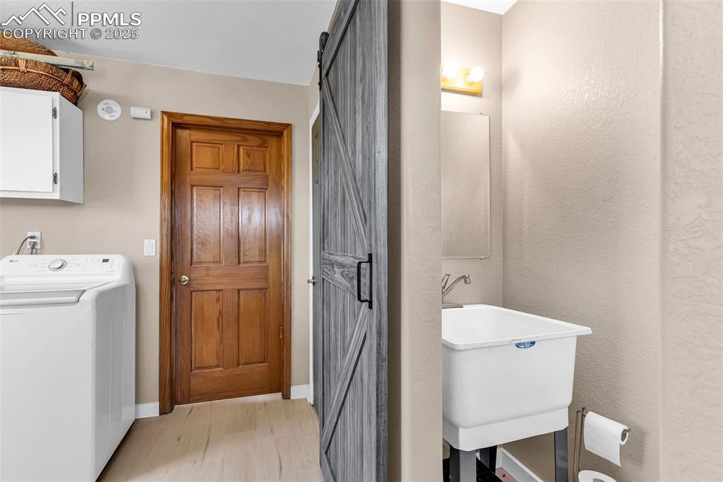 Image 16 of 49: Laundry/Mud room with half bath