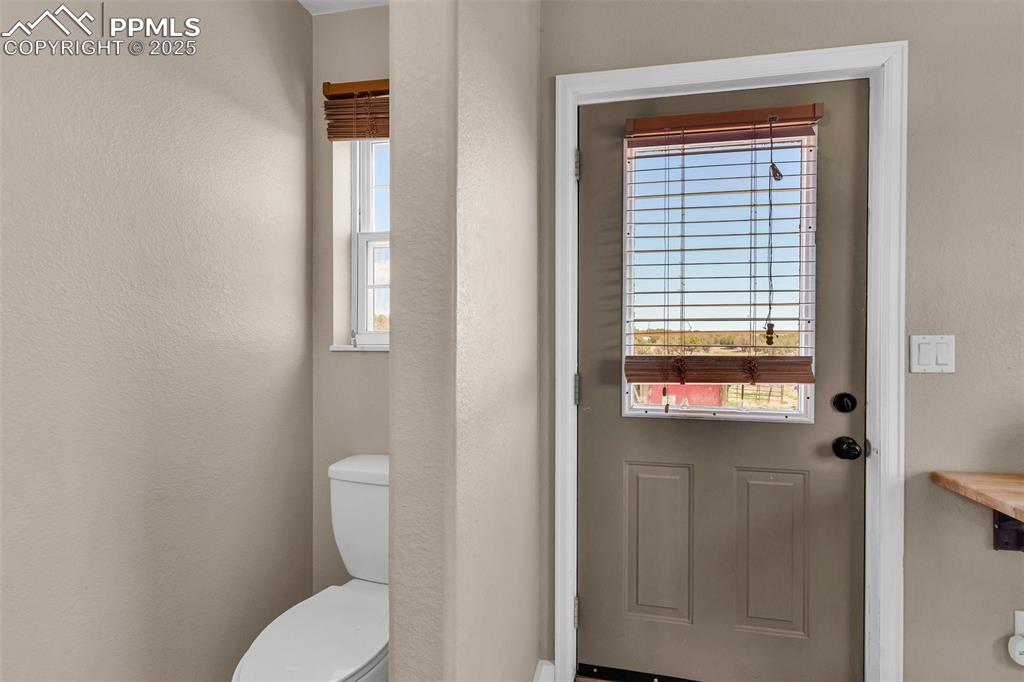 Image 17 of 49: Half bath in laundry/mud room