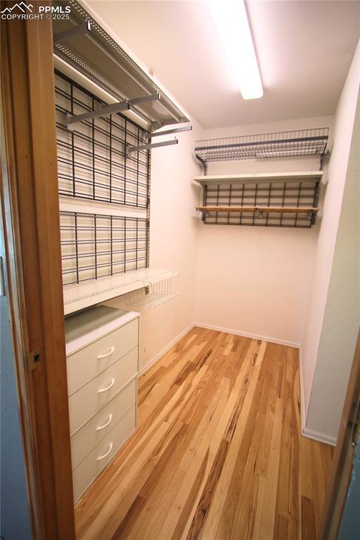 Image 23 of 49: Walk in closet in primary bedroom