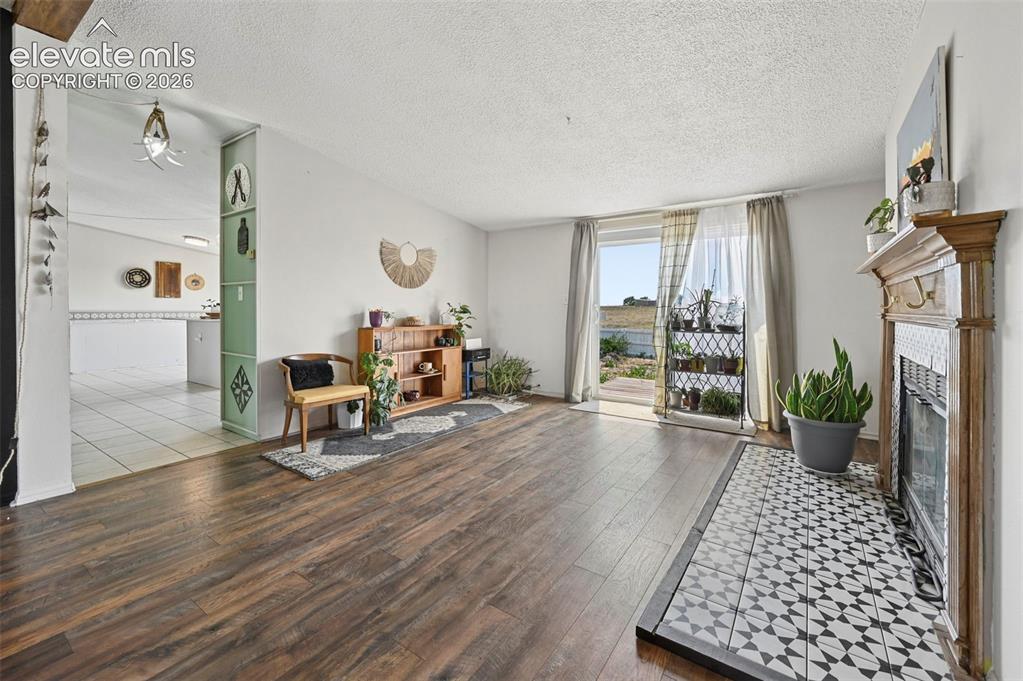 Image 19 of 49: Dining area with Walk out to Backyard Deck and Beautifully Tiled Wood Burni